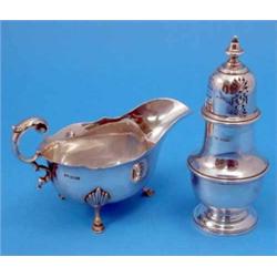 A George V silver sauce boat, with flying scroll handle, Sheffield 1924, and a silver baluster co...