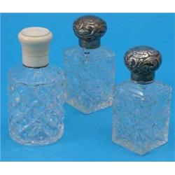 A pair of Victorian silver topped cut glass scent bottles, with foliate decoration, Birmingham 19...