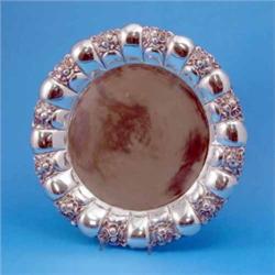 An early 20th century Swedish white metal charger, with a moulded segmented border decorated with...