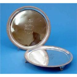 A pair of George III silver salvers, with gadrooned borders and engraved armorials makers Thomas...