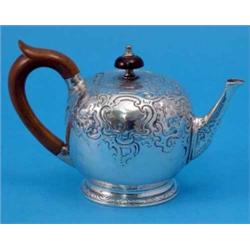 A George II silver bullet shape teapot, with chased foliate rococo decoration and wooden scroll h...