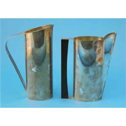 A Gucci white metal ewer, of ovoid form with ebony handle and a further Gucci ewer with loop hand...