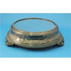 A Britannia metal cake plateau, with gadrooned borders and decorated with chased and repousse flo...
