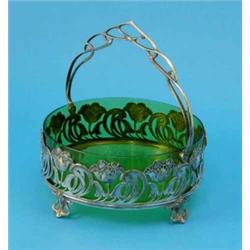 A WMF Art Nouveau plated basket, with green glass liner and decorated with a pierced foliate band...