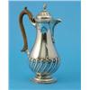 Image 1 : A Victorian silver hotwater pot, of baluster form with wooden scroll handle and demi-fluted spira...