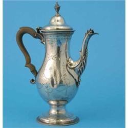 A George III silver coffee pot, of Adam design, with urn shape finial, wooden scroll handle and e...