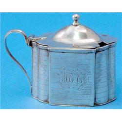 A George III silver serpentine drum mustard, with scroll handle and decorated with wrigglework ba...