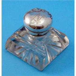 A Continental Art Nouveau white metal and glass inkwell, the hinged lid decorated with a floral s...