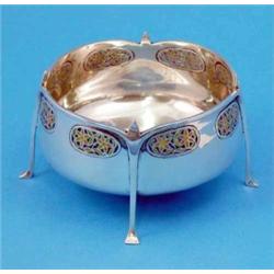 A Liberty and Co Cymric silver and plique a jour enamel bowl, the shaped rim leading to four tape...