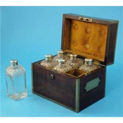 A Regency brass bound rosewood toilet box, the hinged lid enclosing a compartmented interior hous...