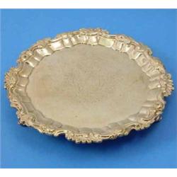 A George II silver salver, decorated with an engraved central armorial within a moulded C scroll...