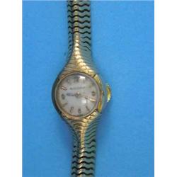 A 1940's lady's 18k gold Jaeger Le Coultre wrist watch with circular dial and integral snake link...