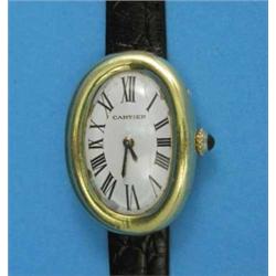 A lady's 18k gold Cartier wrist watch with oval Roman dial and Jaeger Le Coultre movement....