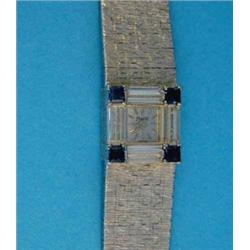 A lady's 18ct white gold Piaget wrist watch, with sapphire and diamond set bezel and textured bra...