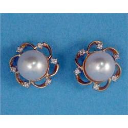 A pair of gold earstuds, each with a central cultured pearl in an openwork border set small diamo...