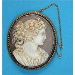 A Victorian shell cameo brooch, carved with a profile study of a lady wearing roses in her hair,...