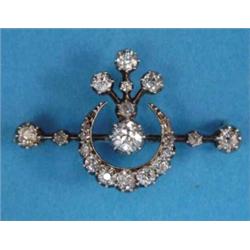 A late Victorian gold and silver diamond set crescent bar brooch (cased)...