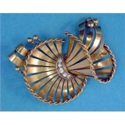 A French 1940's gold brooch, designed as a stylised ribbon tied floral spray set 5 diamonds...