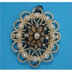 A Victorian seed pearl pendant, mounted with a rose cut diamond set openwork cluster...