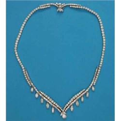 A diamond necklace, set baguette and brilliant cut diamonds, the front panel of slightly graduate...