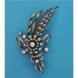 A Victorian entremblant-set diamond brooch, designed as a ribbon tied spray of flowers and wheat...