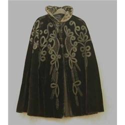 A Victorian black velvet cape, having black tape and beaded fern decoration...