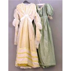 A c. 1810 white muslin gown, in the classical style, the skirt decorated with rows of yellow ribb...