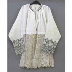 A 19th century ivory linen ecclesiastical robe, having deep lace border, the lace cuffs and neckb...