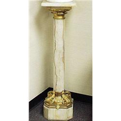 An antique French onyx pedestal with gilt bro...