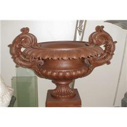 A well cast iron jardiniere. The flaring top...