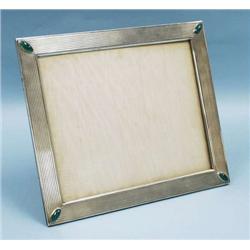 A sterling silver picture frame. Decorated on...