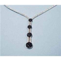 An 18 kt. white gold and diamond necklace. Ce...