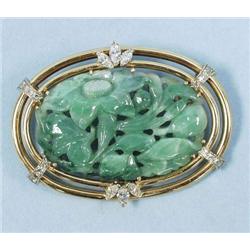 A well carved green jade pendant brooch set i...