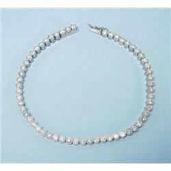 A platinum and diamond line bracelet designed...