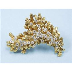 An 18 kt. gold and diamond pendant brooch in...
