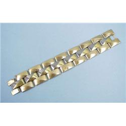 A wide 18 kt. three tone gold bracelet design...