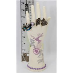 HAND DISPLAY FILLED WITH VARIOUS FASHION RINGS