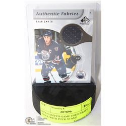 RYAN SMYTH GAME USED JERSEY PIECE WITH PUCK STAND