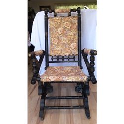 Vintage wooden rocking chair with rollers on the front. 41" from floor to top of back, 22" wide and 