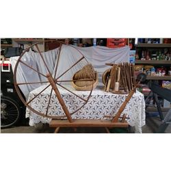 Spinning wheel with basket of niddie noddies, shuttles and basket of twine. 72" L x 60" H x 6 ½" W