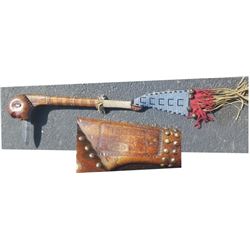 Ball war club, with carved face with spear point coming from mouth