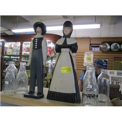 1 2 WOODEN PILGRIM FIGURINES & 6 GLASS MILK CONTAINERS