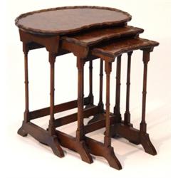 Kidney shaped walnut nest of three tables o…