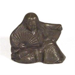 Japanese cast metal figure of a woman clutc…