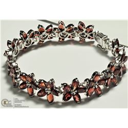32) STERLING SILVER GARNET FLOWER SHAPED BRACELET