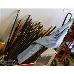 WOOD ROLLING BIN FULL OF FLAG POLES , WHEEL LOOSE.