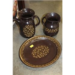 TWO CERAMIC PITCHERS AND TRAYS