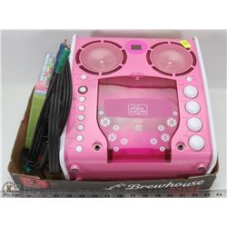 PINK KARAOKE MACHINE WITH MIC AND DISKS.