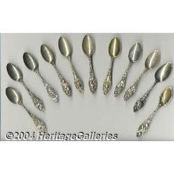 A GROUP OF ELEVEN SILVER FRUIT HANDLE SOUVENIR SPOONS