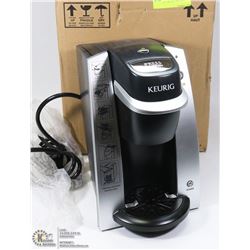NEW IN BOX KEURIG MACHINE.